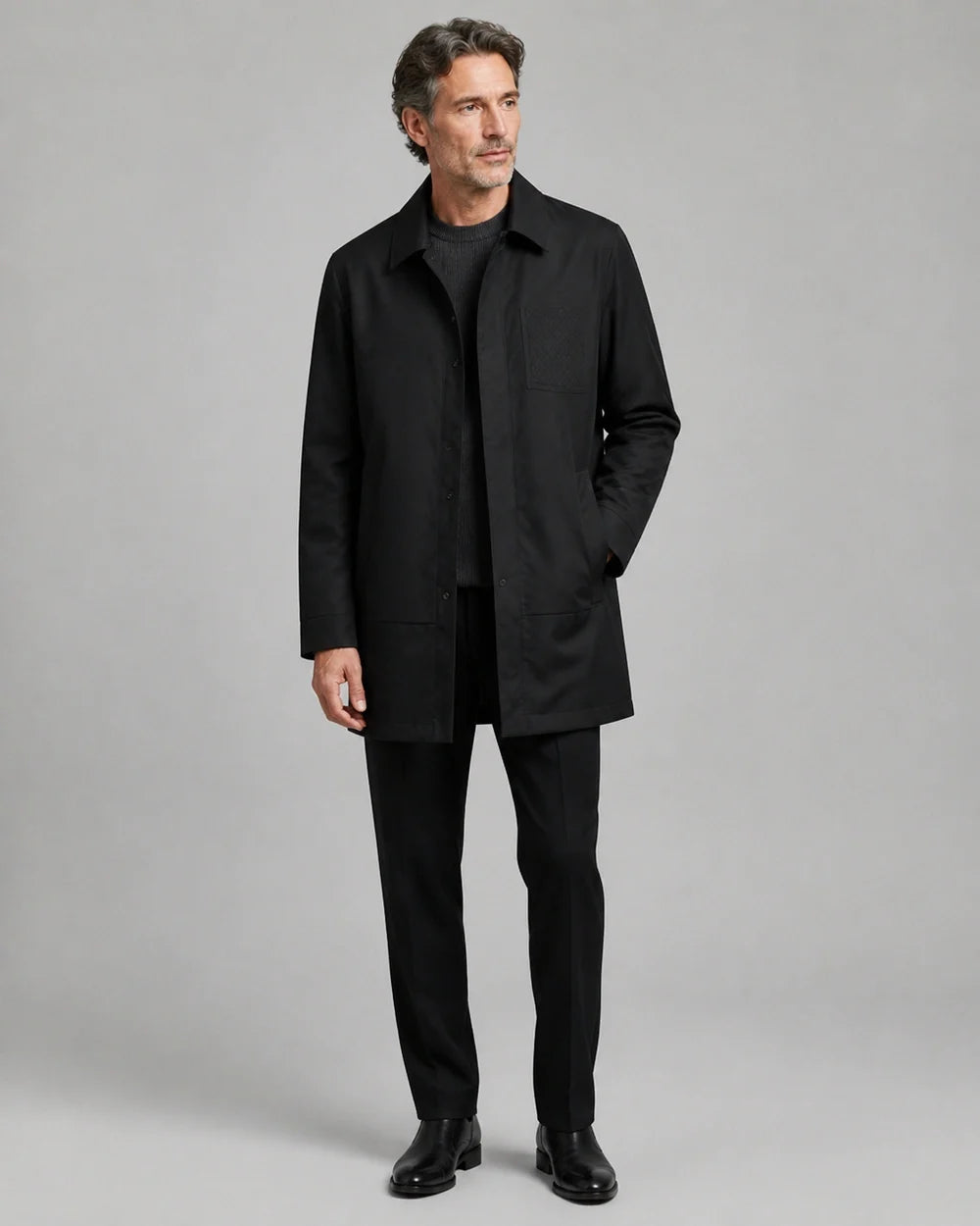 Black mid-length coat for men, worn full-length hero view.