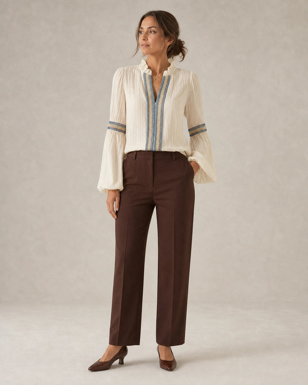 Women's ivory vintage blouse with embroidered trim, complete silhouette.