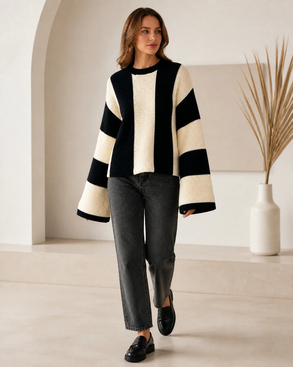 Women's beige black-and-cream color-block sweater, walking view