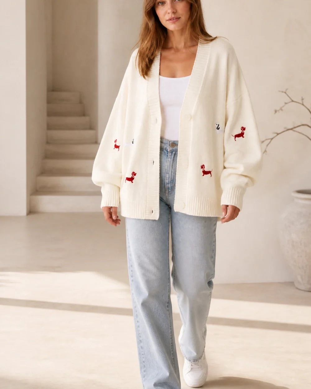 Women's white dachshund motif cardigan, walking lifestyle view