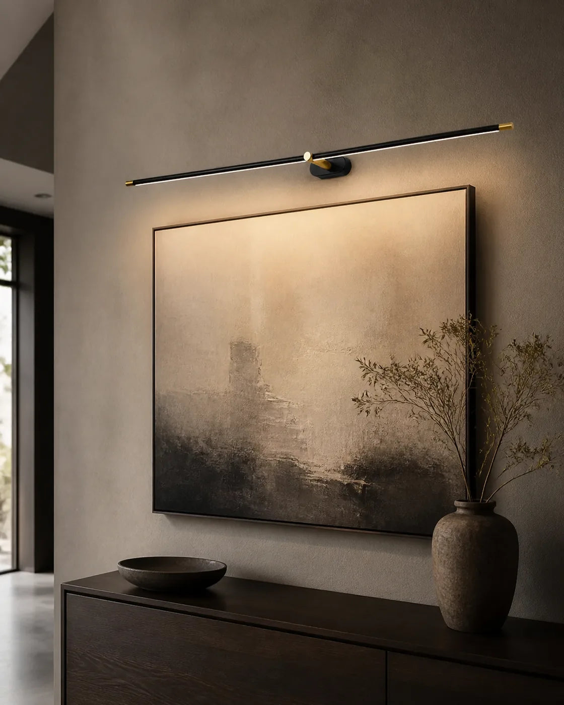 Black Linear LED Wall Lamp illuminating framed artwork