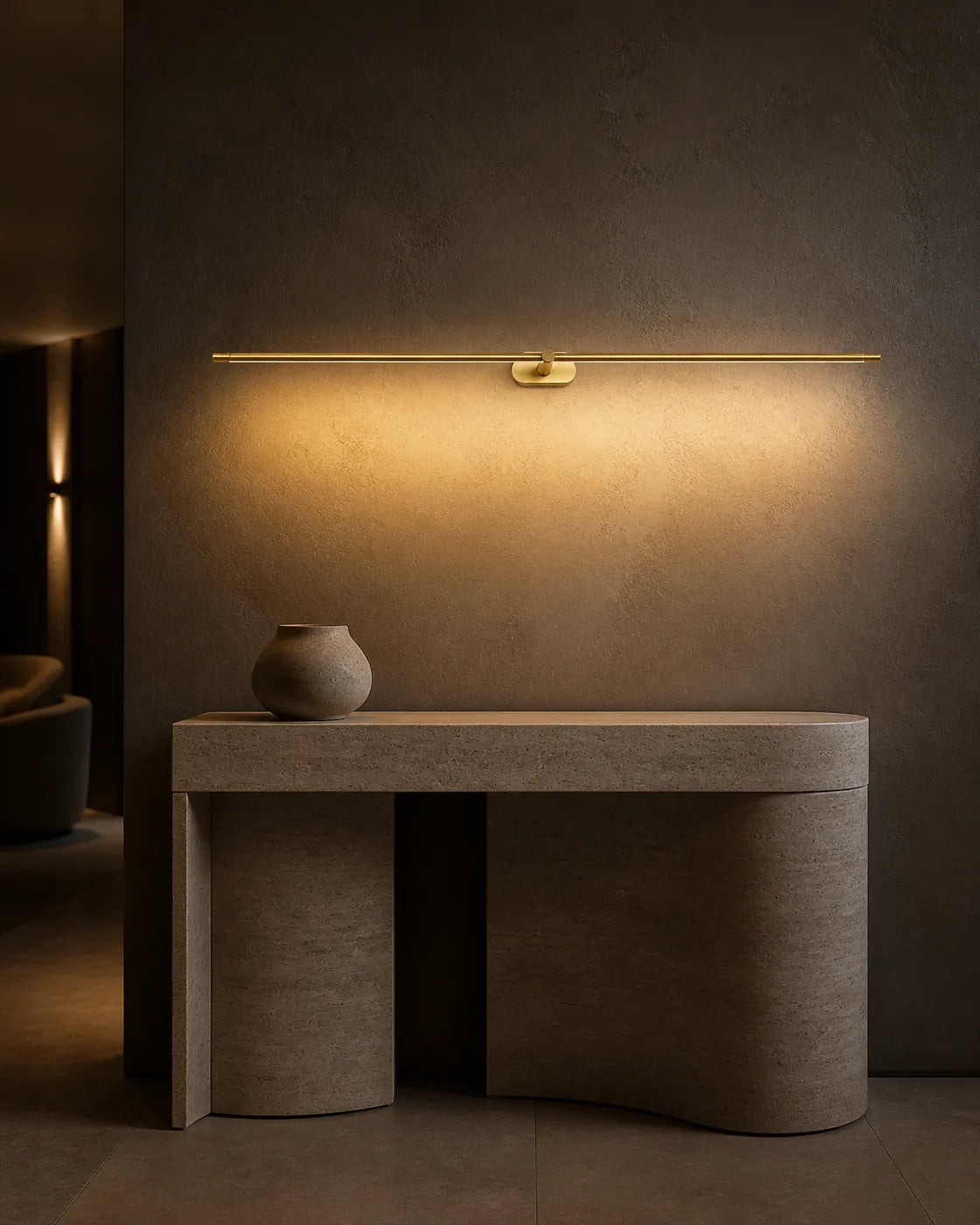 Gold Linear LED Wall Lamp above a travertine console