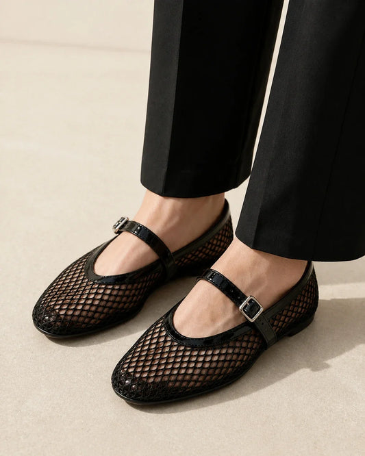 Women’s black mesh Mary Jane ballet flats, worn close-up front three-quarter view.