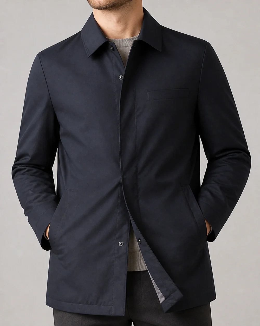 Dark blue mid-length coat for men, collar and closure detail.