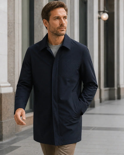 Dark blue mid-length coat for men, city lifestyle view.