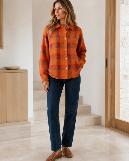 Women's orange checked button-front knit with dark denim styling.