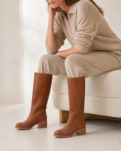 Brown round-toe knee-high boots, seated styling